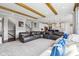 Open-concept living area features stone fireplace, wood beams, and modern kitchen at 14747 Harvest Glen S Blvd, Fishers, IN 46037