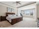 Bright main bedroom with a tray ceiling, ceiling fan, large windows, and a dark wood bedroom set at 14747 Harvest Glen S Blvd, Fishers, IN 46037
