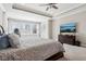 This large main bedroom features lots of windows and a tray ceiling with fan at 14747 Harvest Glen S Blvd, Fishers, IN 46037
