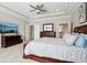 Main bedroom with tray ceilings, hardwood furniture, large windows, and access to both a bathroom and closet at 14747 Harvest Glen S Blvd, Fishers, IN 46037
