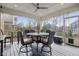Screened patio with outdoor dining set, ceiling fan, and views of backyard and neighborhood at 14747 Harvest Glen S Blvd, Fishers, IN 46037