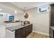 Basement wet bar featuring granite countertops, a stainless steel sink, and custom cabinets at 14747 Harvest Glen S Blvd, Fishers, IN 46037