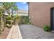 Brick house featuring backyard patio with trees and greenery around its perimeter at 1537 Carrollton Ave, Indianapolis, IN 46202