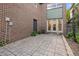 Brick house featuring backyard patio with trees and greenery around its perimeter at 1537 Carrollton Ave, Indianapolis, IN 46202