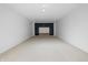 Spacious basement featuring neutral carpet, white walls and a dark accent wall with built-in shelving at 1537 Carrollton Ave, Indianapolis, IN 46202