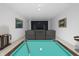 Basement with theater seating, pool table, and decorative movie posters on the white walls at 1537 Carrollton Ave, Indianapolis, IN 46202