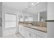 Modern bathroom with double sinks, granite countertops, and sleek white cabinetry at 1537 Carrollton Ave, Indianapolis, IN 46202