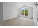 Bright bedroom with a large window offering natural light and treetop views at 1537 Carrollton Ave, Indianapolis, IN 46202