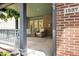 Inviting front porch with comfortable seating, decorative plants, and brick accents, perfect for relaxation and curb appeal at 1537 Carrollton Ave, Indianapolis, IN 46202