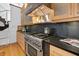 Well-equipped kitchen showcasing a stainless steel stove with a modern range hood and dark countertops at 1537 Carrollton Ave, Indianapolis, IN 46202