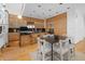 Modern kitchen features light wood cabinetry, sleek black countertops, and stainless steel appliances with seating area at 1537 Carrollton Ave, Indianapolis, IN 46202