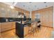 Modern kitchen with sleek stainless steel appliances, an island with bar seating, and light wood cabinets at 1537 Carrollton Ave, Indianapolis, IN 46202