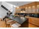 Modern kitchen with light wood cabinetry, stainless steel appliances, and a large island with woven bar stools at 1537 Carrollton Ave, Indianapolis, IN 46202