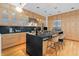 Bright kitchen featuring wood cabinets, stainless steel appliances, and a large island with bar seating at 1537 Carrollton Ave, Indianapolis, IN 46202