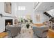 Bright, open-concept living room featuring a fireplace, hardwood floors, and large windows allowing ample natural light at 1537 Carrollton Ave, Indianapolis, IN 46202