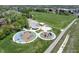 Aerial view of community playground with modern equipment, a covered shelter, and walking trail at 1537 Carrollton Ave, Indianapolis, IN 46202