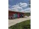 Exterior of community restrooms with colorful art mural and a bench nearby at 1537 Carrollton Ave, Indianapolis, IN 46202