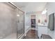 Bathroom featuring a glass shower and a view into the closet with shelves and hanging space at 1695 Jackson St, Fortville, IN 46040