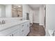 Bright bathroom featuring a double vanity, large mirror, and a tiled shower with a glass door at 1695 Jackson St, Fortville, IN 46040