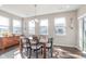 A dining area showcasing a table, seating for six, and bright, natural lighting at 1695 Jackson St, Fortville, IN 46040