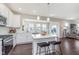 Modern kitchen featuring an island with bar seating, stainless steel appliances, and a view into the living area at 1695 Jackson St, Fortville, IN 46040