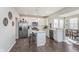 Kitchen features white cabinets, stainless steel appliances, central island, and hardwood flooring at 1695 Jackson St, Fortville, IN 46040