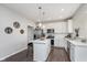 Modern kitchen with white cabinets, stainless steel appliances, and island with breakfast bar at 1695 Jackson St, Fortville, IN 46040