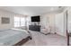 Cozy main bedroom with large window, plush carpet, accent chair, and natural light at 1695 Jackson St, Fortville, IN 46040