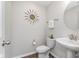 Stylish powder room featuring modern fixtures, vanity sink, and contemporary decor, plus sleek hardwood floors at 1695 Jackson St, Fortville, IN 46040