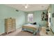 Charming bedroom featuring light green walls, vintage furniture and an abundance of natural light at 1716 Teakwood Ct, Lafayette, IN 47905