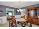 Formal dining room with a wooden table, china cabinet, and access to the living room at 1716 Teakwood Ct, Lafayette, IN 47905