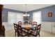 Formal dining room featuring wood table, chandelier, and blue accent walls at 1716 Teakwood Ct, Lafayette, IN 47905