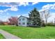 Charming two-story home with blue siding, manicured lawn, and mature trees at 1716 Teakwood Ct, Lafayette, IN 47905