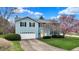 Beautiful two-story home with blue siding, mature trees, and landscaped yard at 1716 Teakwood Ct, Lafayette, IN 47905