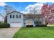 Charming two-story home with blue siding, yellow front door and an attached two car garage at 1716 Teakwood Ct, Lafayette, IN 47905
