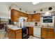 Open kitchen featuring wood cabinets, tile floors and a large window at 1716 Teakwood Ct, Lafayette, IN 47905