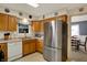 Bright kitchen with stainless steel refrigerator and view to dining room at 1716 Teakwood Ct, Lafayette, IN 47905