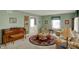 Inviting living room with a piano and ample seating with lots of natural light at 1716 Teakwood Ct, Lafayette, IN 47905