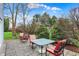 Back patio area with furniture, pavers, and mature landscaping at 1716 Teakwood Ct, Lafayette, IN 47905