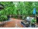 Spacious deck offers tranquil views with outdoor furniture, planters and blue patterned outdoor rug at 2143 Sunderland Dr, Martinsville, IN 46151