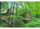 Home's exterior showcasing an elevated deck, embraced by lush trees, enhancing privacy and a connection with nature at 2143 Sunderland Dr, Martinsville, IN 46151