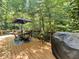 Wood back deck surrounded by lush greenery, perfect for outdoor dining at 2143 Sunderland Dr, Martinsville, IN 46151