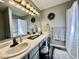 Well-lit bathroom with a double sink vanity, modern fixtures, and decorative accents at 2143 Sunderland Dr, Martinsville, IN 46151