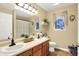 Neutral bathroom with double sinks, natural wood floors and decorative plants at 2143 Sunderland Dr, Martinsville, IN 46151