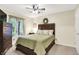 Bedroom featuring a dark wood bed frame, ceiling fan, and natural light at 2143 Sunderland Dr, Martinsville, IN 46151