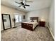 Cozy bedroom featuring a ceiling fan, soft carpet, and a dark wood bed frame at 2143 Sunderland Dr, Martinsville, IN 46151