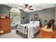 Cozy bedroom with a window, dresser, and antique style metal bed frame at 2143 Sunderland Dr, Martinsville, IN 46151