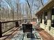 Spacious wooden deck with views of wooded backyard, and an outdoor seating area at 2143 Sunderland Dr, Martinsville, IN 46151