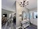 Inviting entryway with chandelier, mirror, table, and views into the living room and dining area at 2143 Sunderland Dr, Martinsville, IN 46151