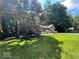 Beautiful brick home with mature trees, lush lawn, and charming front yard garden at 2143 Sunderland Dr, Martinsville, IN 46151
